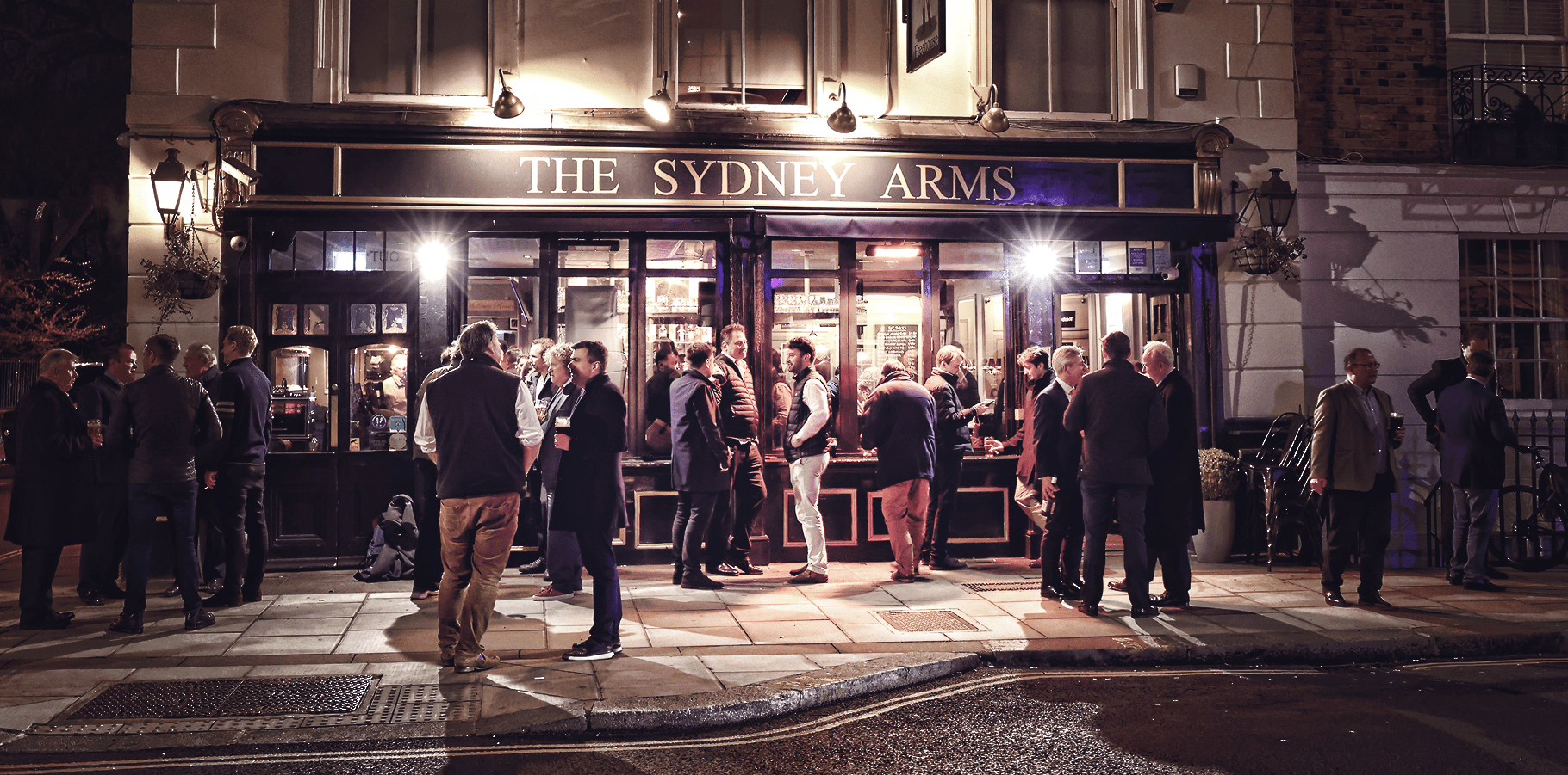 Front view of The Sydney Arms with people standing outside